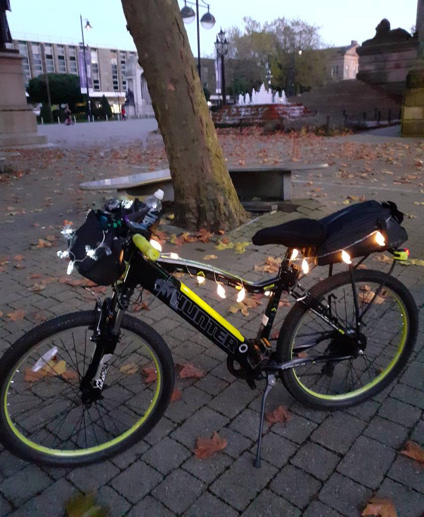 An electrically assisted bicycle with Halloween lights on the frame. (Thanks to June Leece)